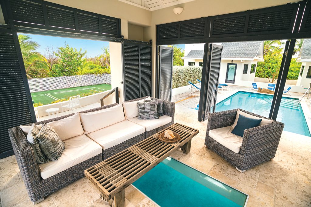 InPickleball | Grand Cayman | The Caribbean beach is just a short stroll from Villa Amoraflora, which has a pool with a pavilion over it as well as a private pickleball court